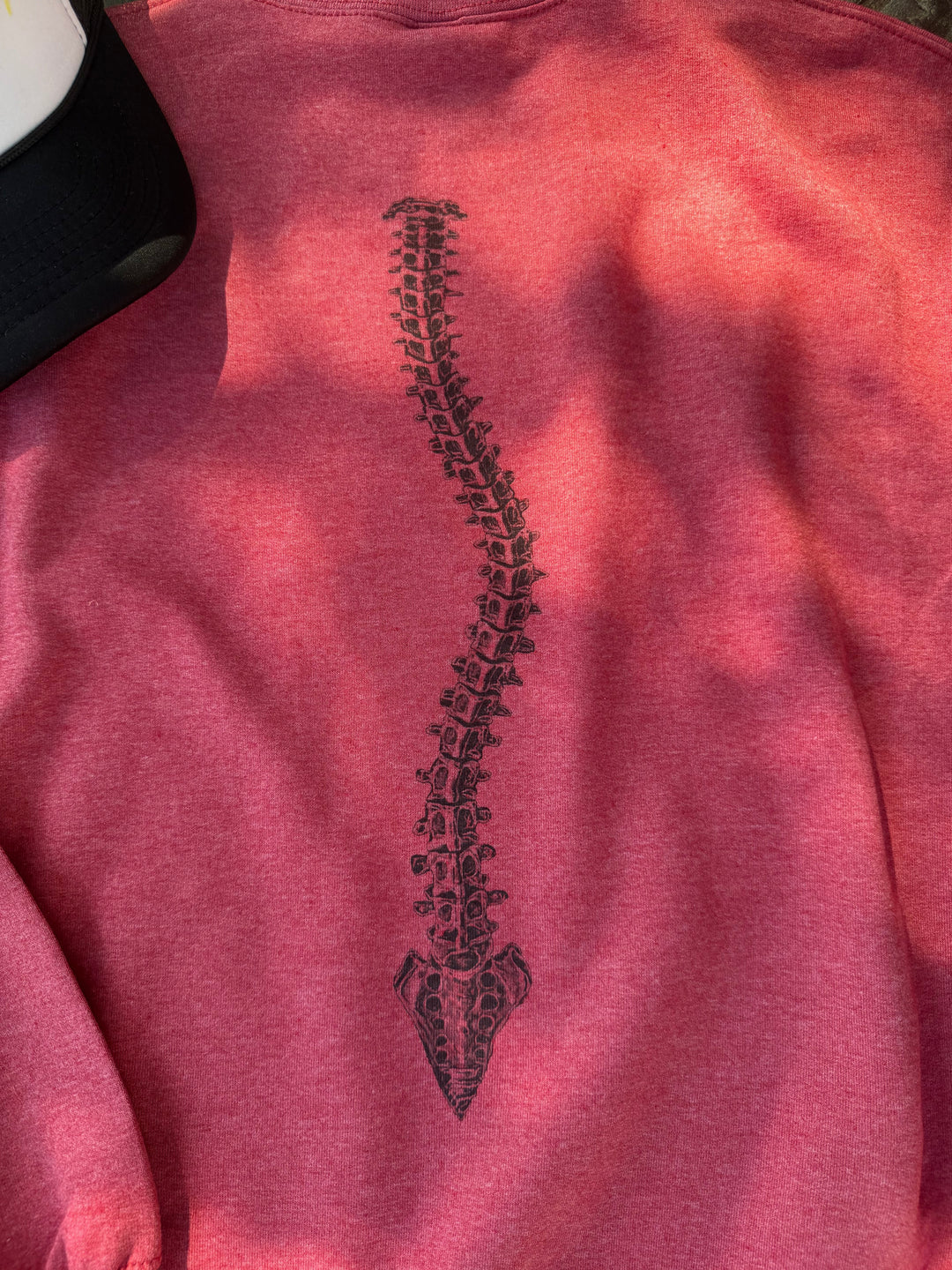 Bent, not Broken curved spine design on back of red heather sweatshirt