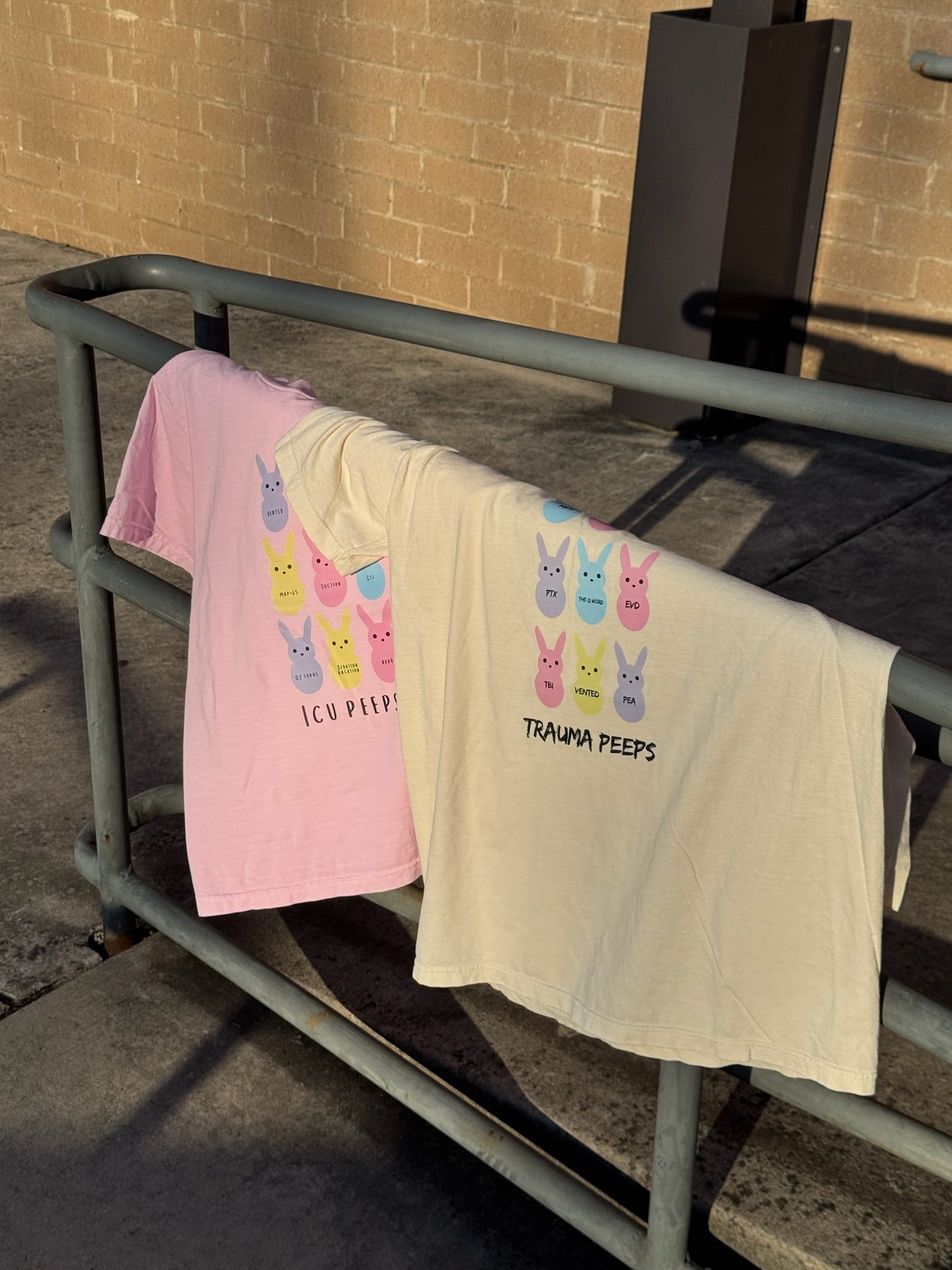 Trauma Squad and ICU Squad tee shirts with pastel bunny designs on a metal railing.