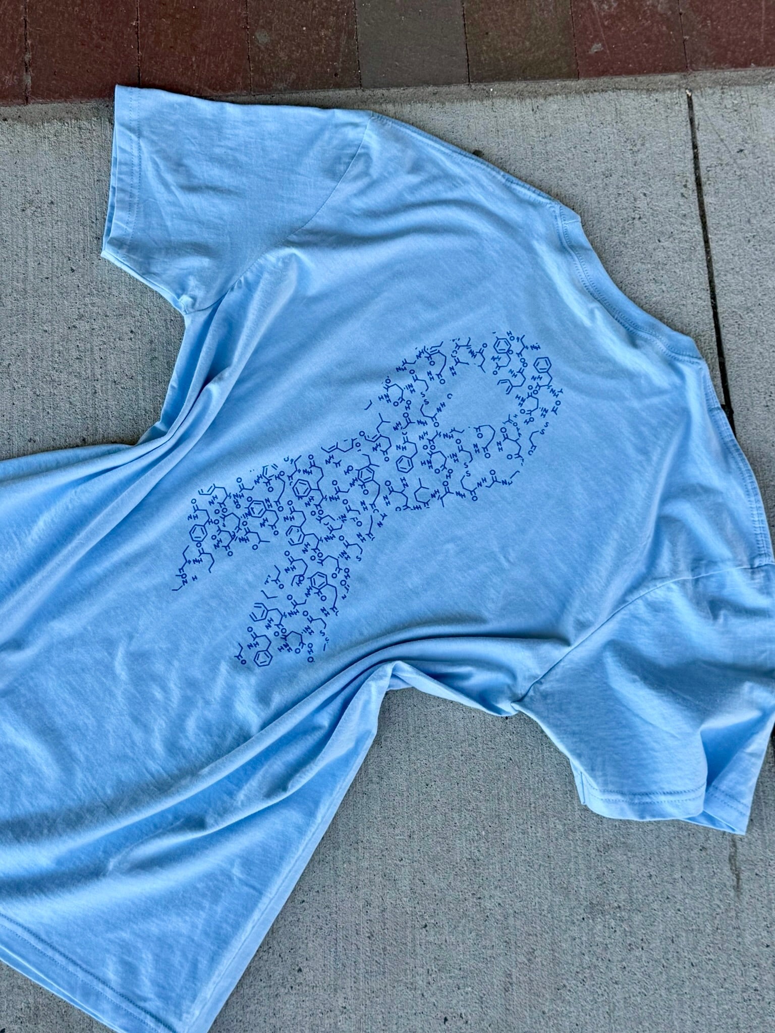 Blue Diabetes Awareness Tee with blue ribbon made up on insulin molecules