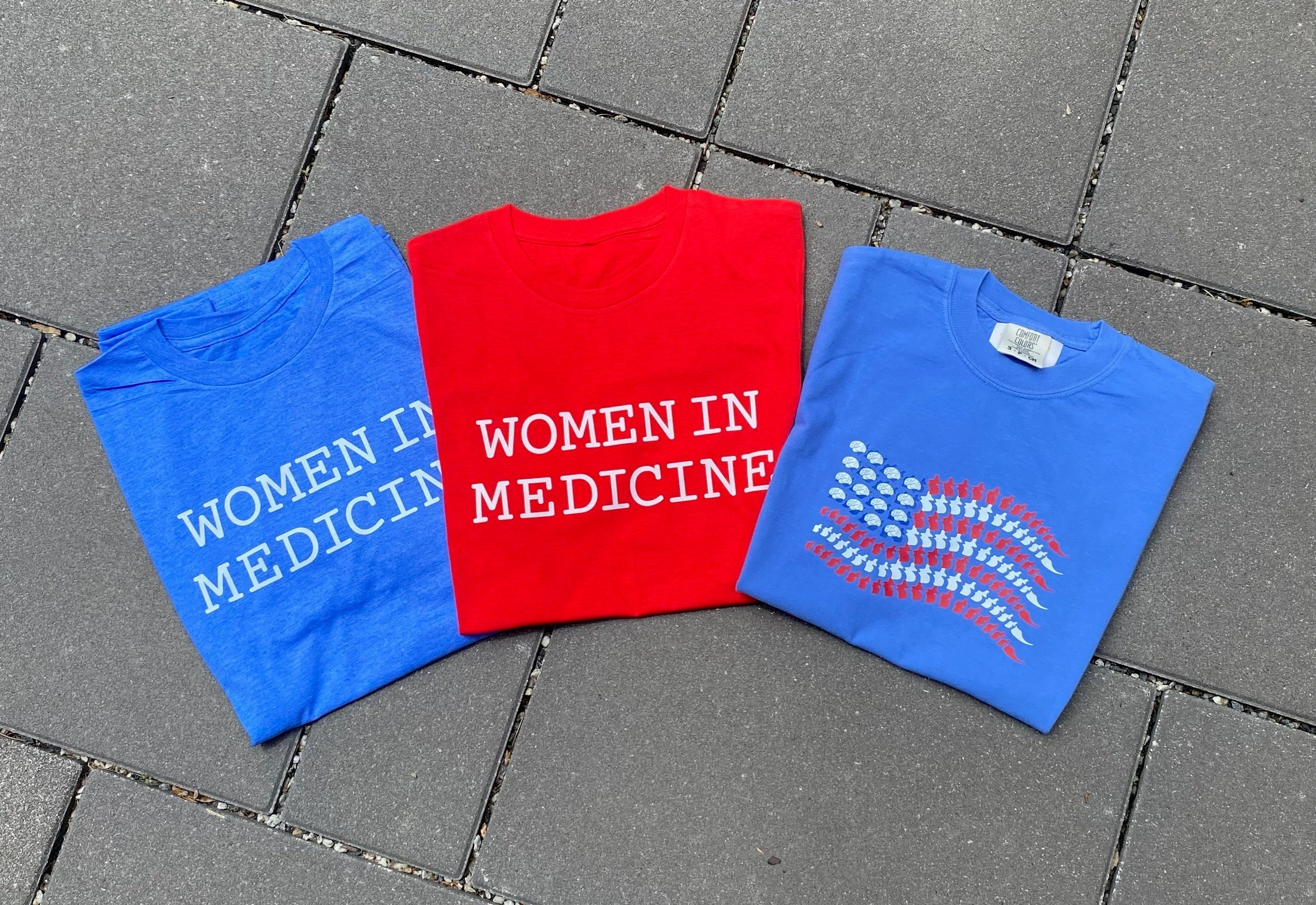 red white and blue t shirts on a tiled ground