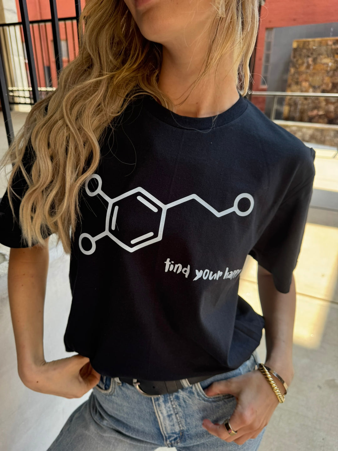 Person wearing a black t-shirt with a dopamine chemical structure design and 'find your happy' text.