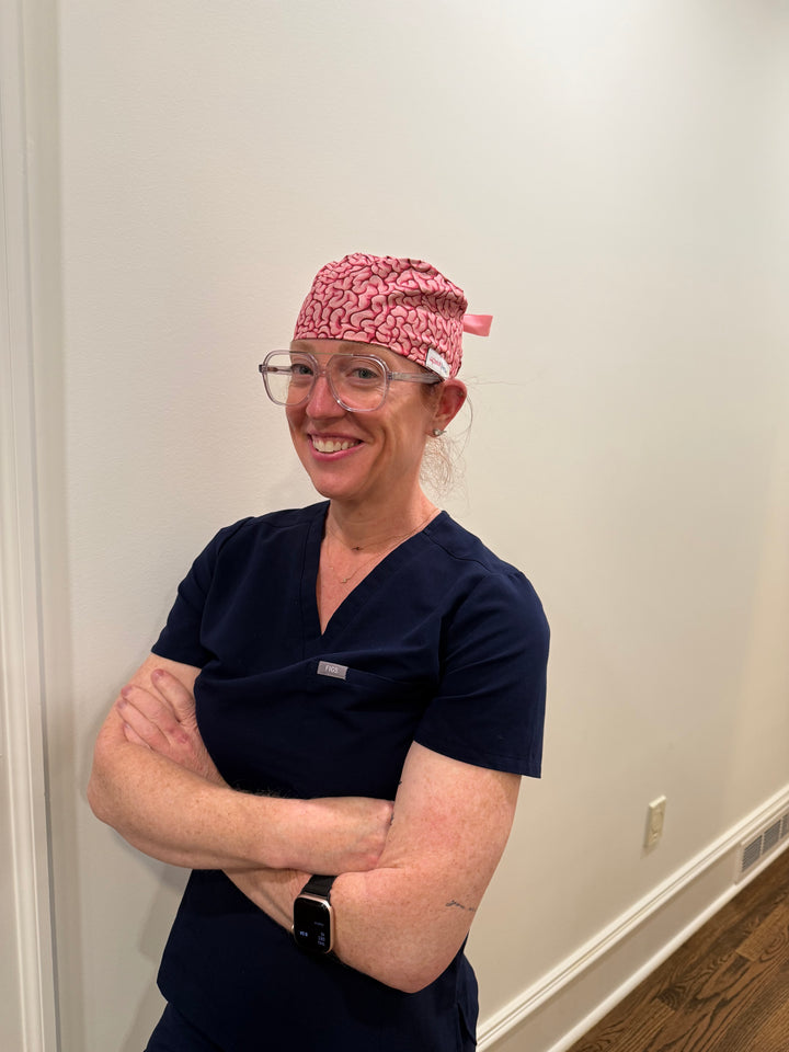 Dr. Betsy Grunch (Ladyspinedoc) wearing her pink Cortex Scrub Hat with brain design
