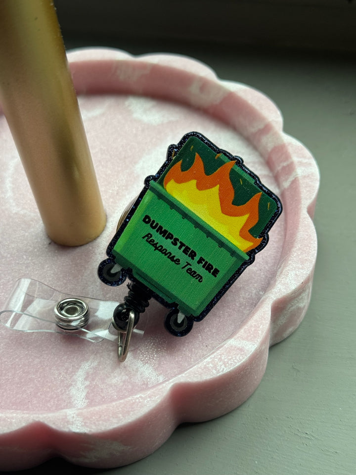 Ladyspinedoc Dumpster Fire Response Team Badge Reel - Retractable with Alligator Clip, displayed in pink tray.
