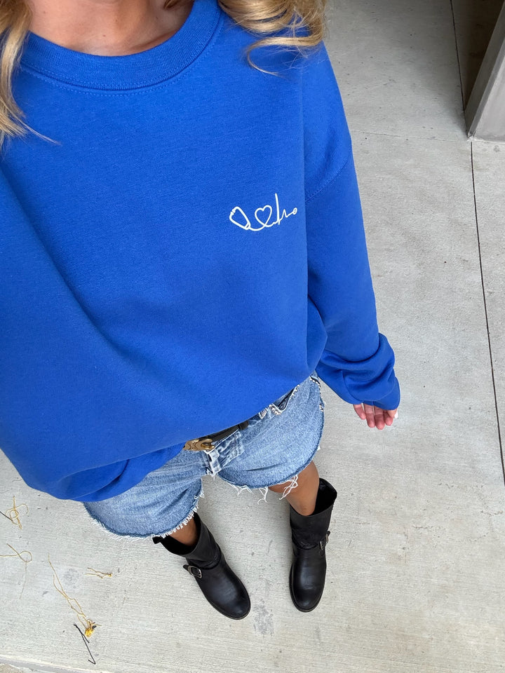 Front view of model wearing Heart of Medicine Crewneck Sweatshirt - Royal Blue