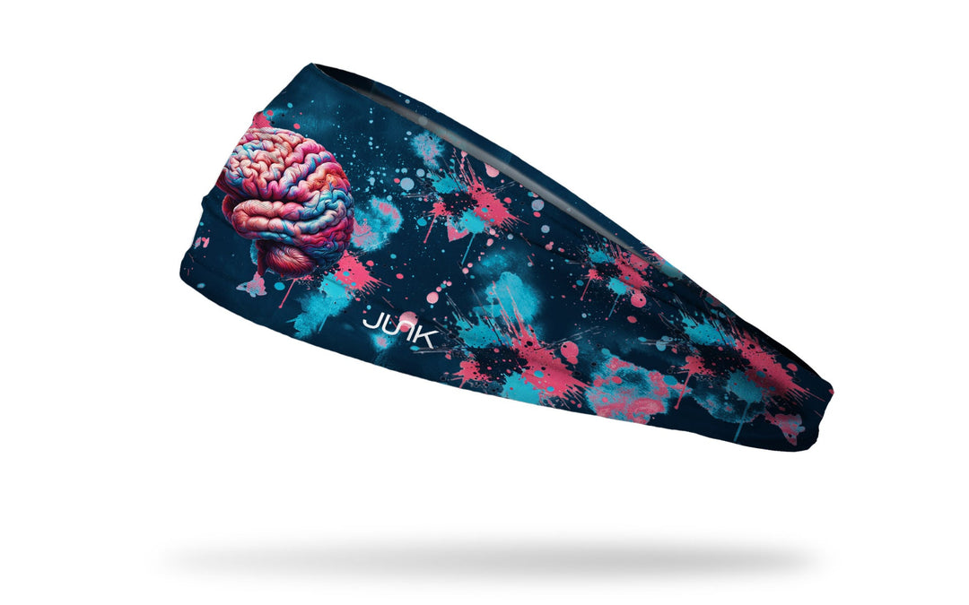 Black Ladyspinedoc x Junk athletic headband with a colorful brain design and pink and blue spatter paint on a dark blue background