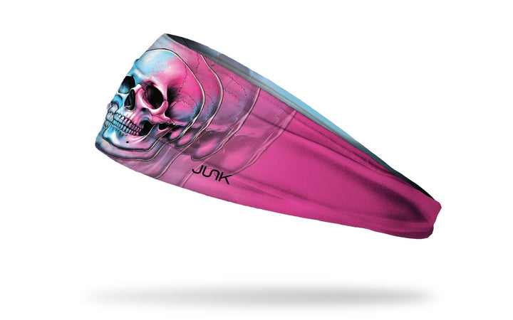 A pink and blue Ladyspinedoc x Junk athletic headband with a skull design on the front