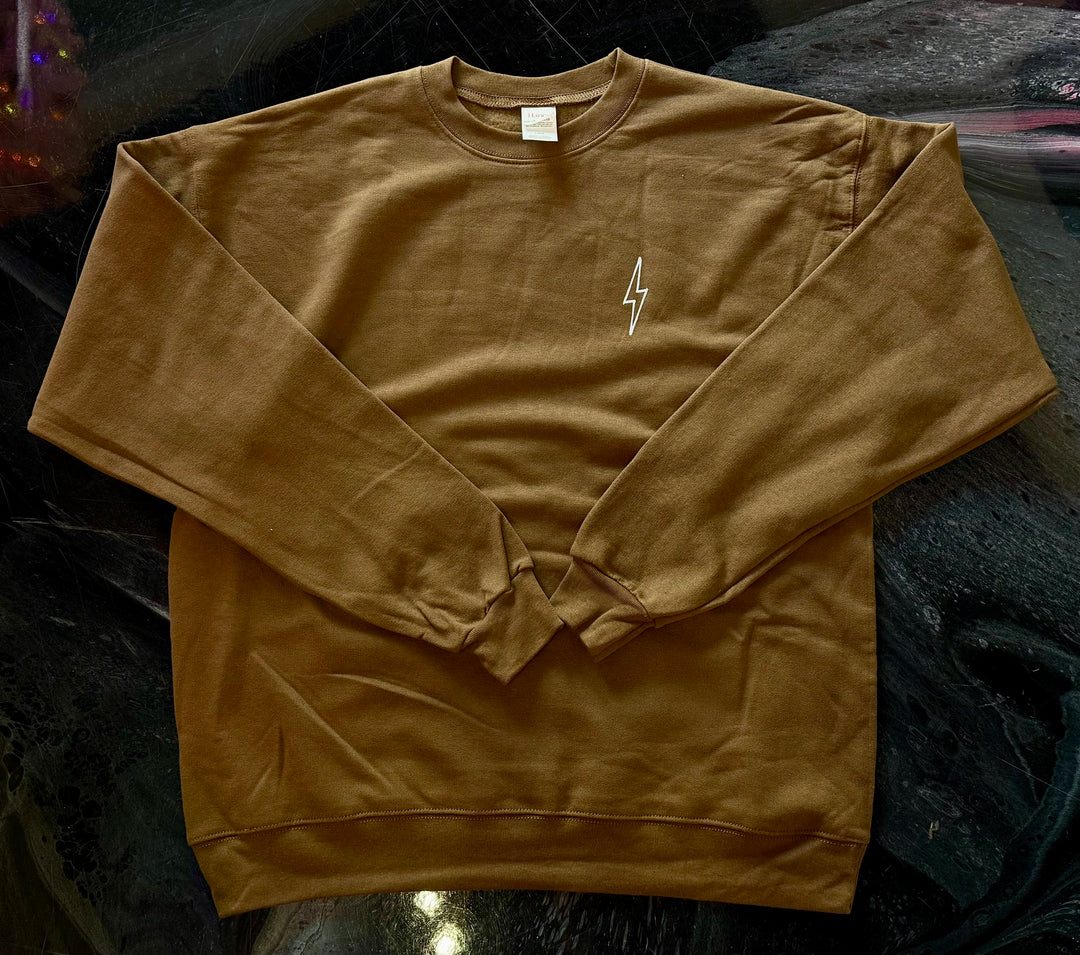 Front of brown-colored Increcible sweatshirt with a white lightning bolt design on a dark background