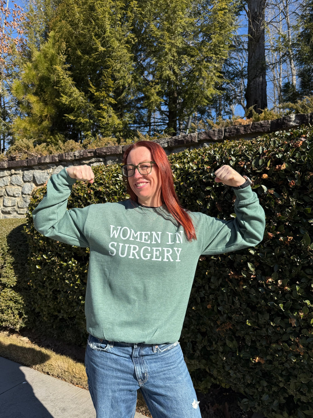 Ladyspinedoc wearing a green Women in Surgery sweatshirt outside