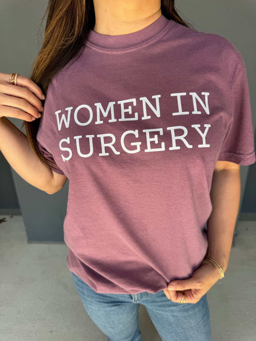 Person wearing a burgundy 'Women in Surgery' t-shirt