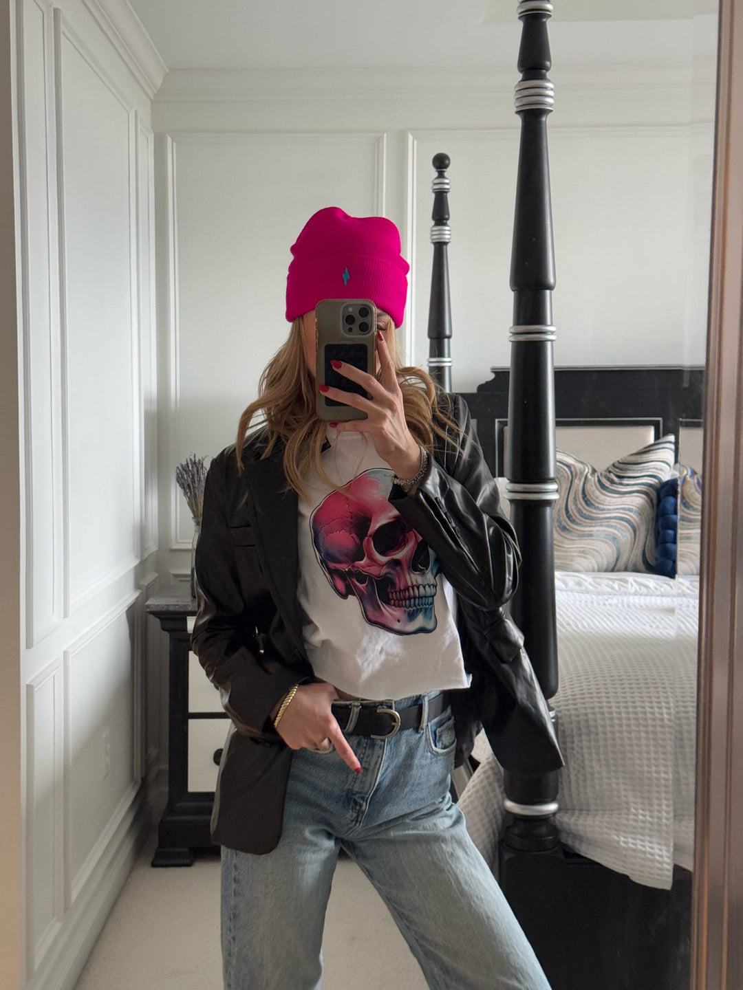 Model wearing the Skull Style Cropped Tee – White Short Sleeve Crop Top with Skull Design and pink beanie