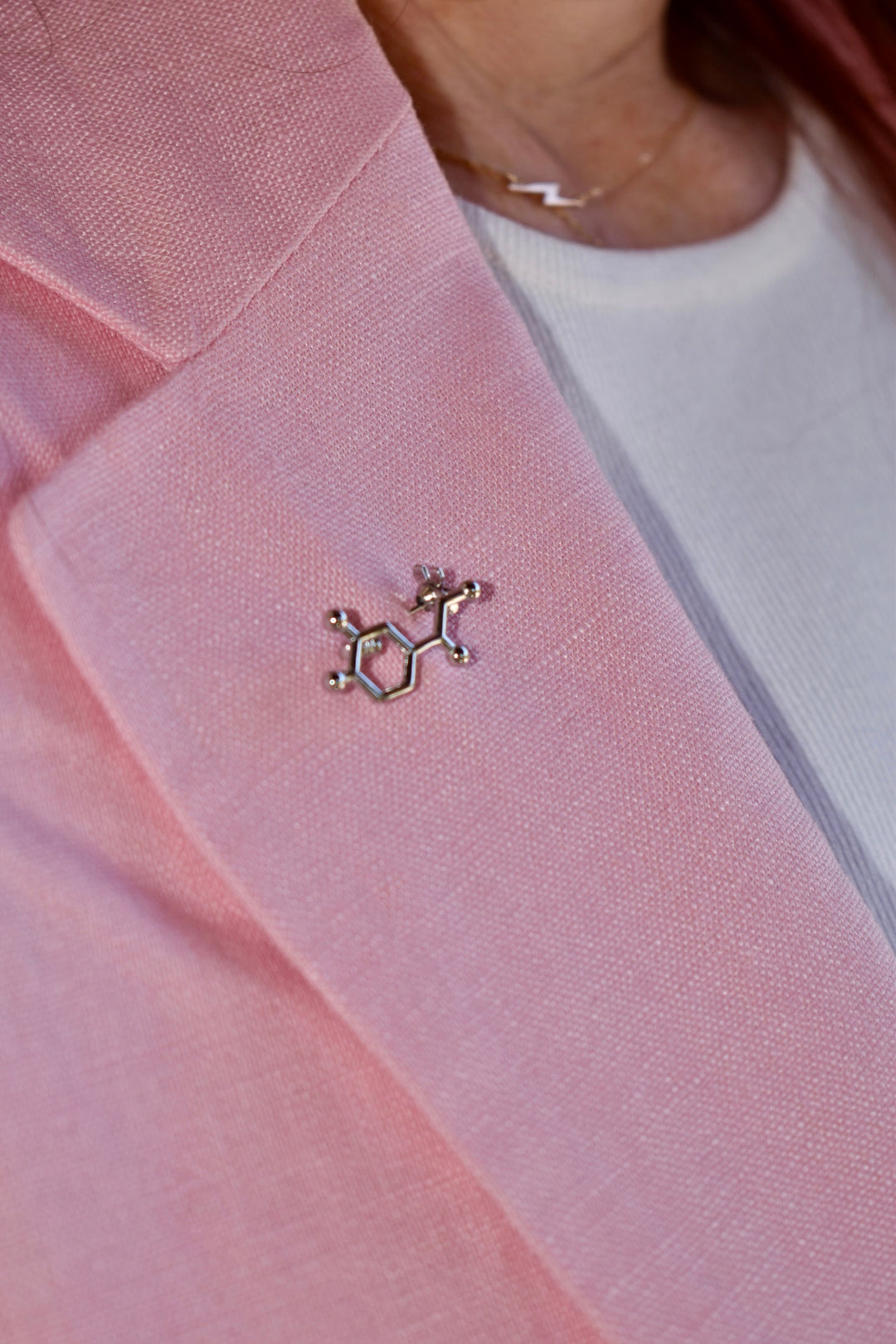 Ladyspinedoc wearing pink blazer with a silver  Noradrenaline Molecule Lapel Pin