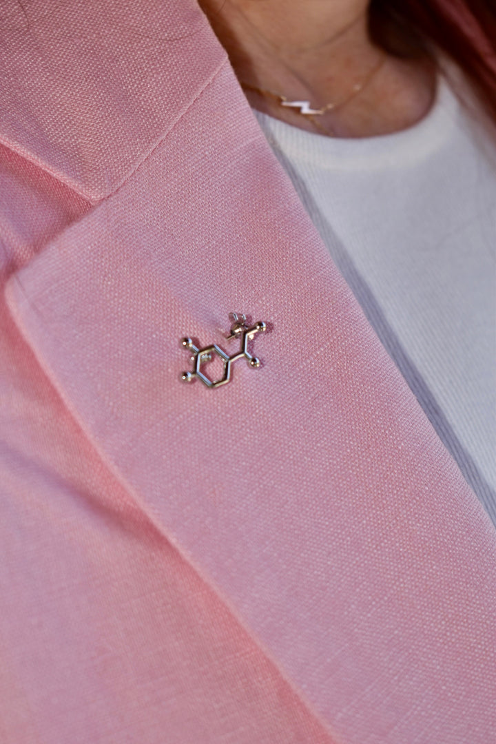 Ladyspinedoc wearing pink blazer with a silver  Noradrenaline Molecule Lapel Pin