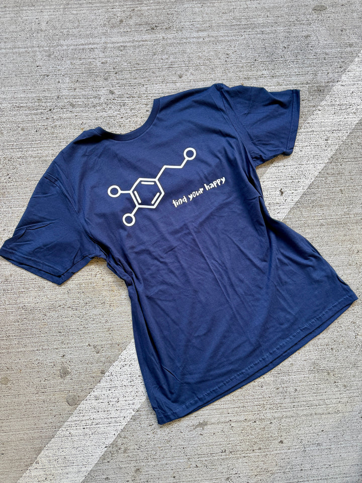 Blue t-shirt with a white dopamine molecule graphic design on a concrete surface