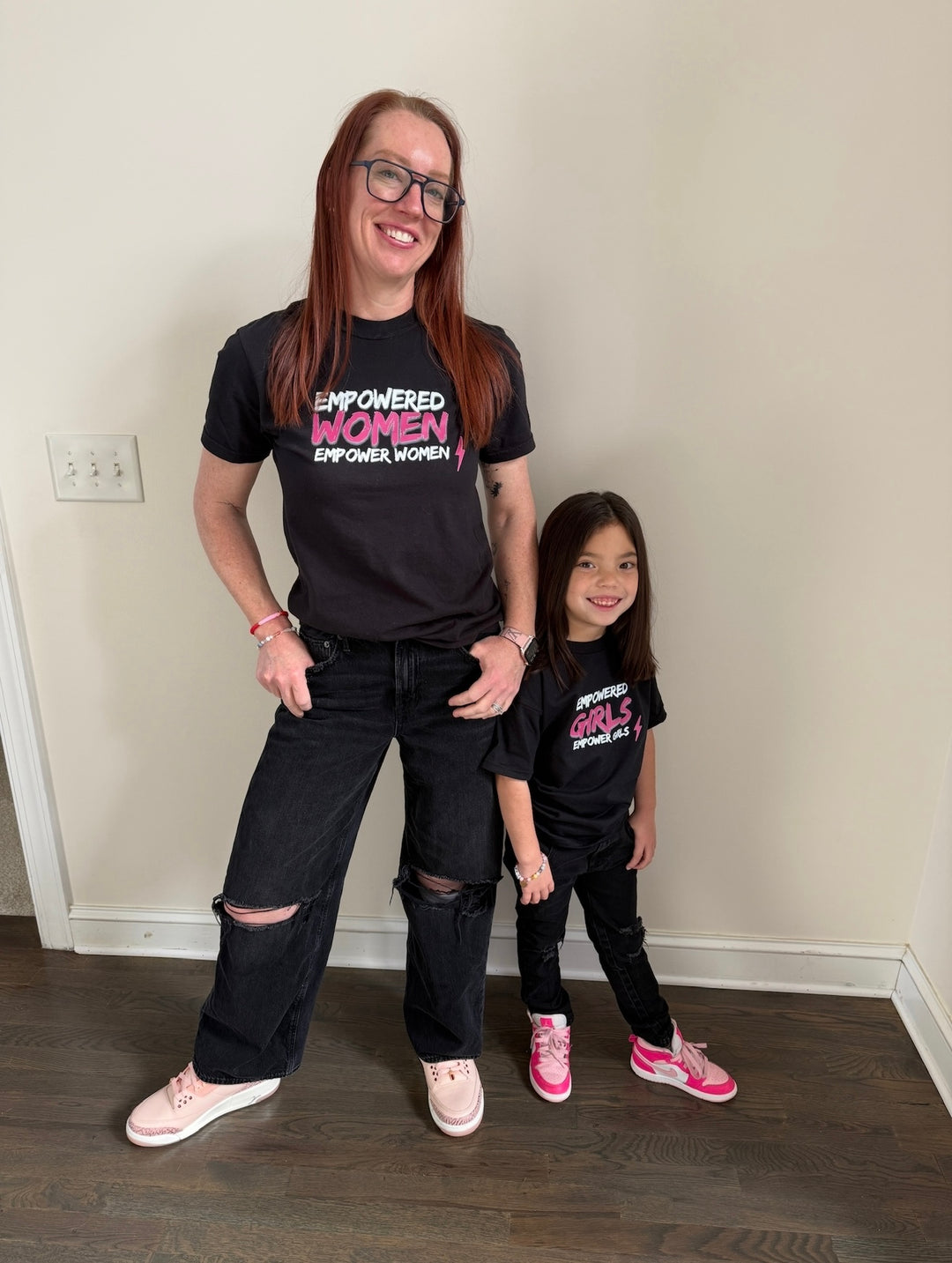 Ladyspinedoc and daughter wearing black Empowered Women and Empowered Girls tees
