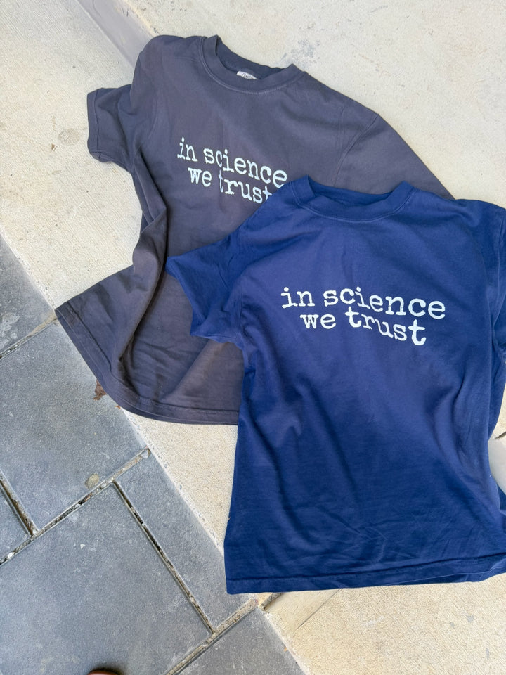 navy shirt and dark gray shirt with the phrase in science we trust (in white) on it