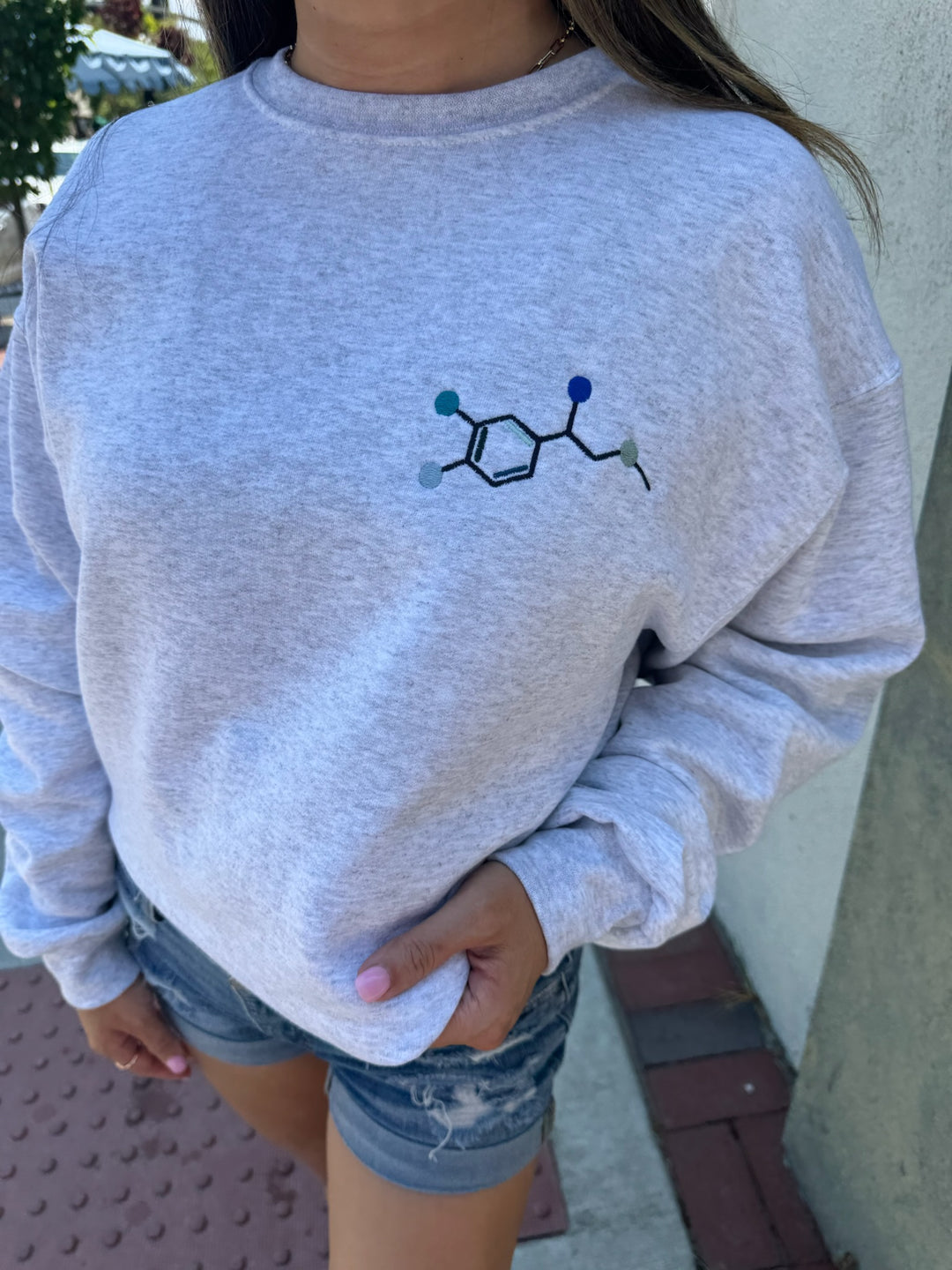 Model wearing Ladyspinedoc Code Cart Crewneck Sweatshirt - Gray Shirt with Embroidered Epinephrine (Adrenaline) Molecule Design