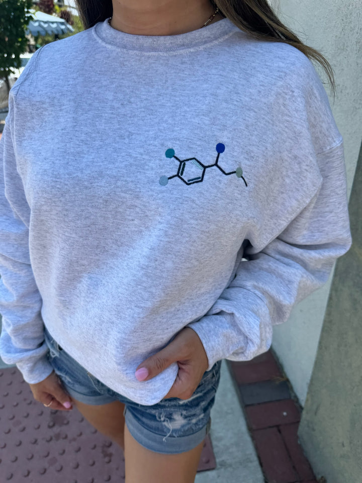 Model wearing Ladyspinedoc Code Cart Crewneck Sweatshirt - Gray Shirt with Embroidered Epinephrine (Adrenaline) Molecule Design