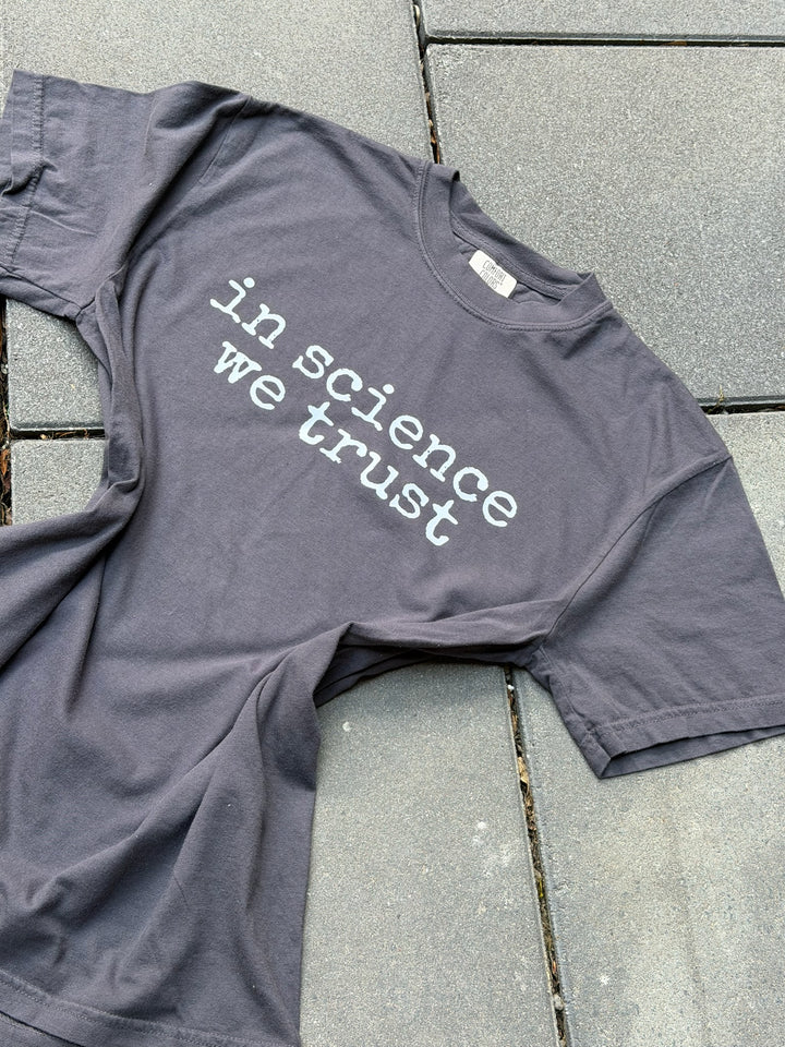 gray shirt with the phrase in science we trust in white font