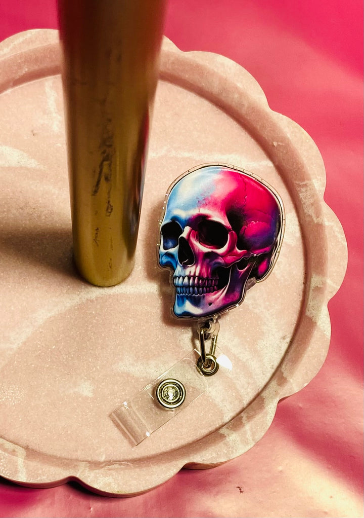 Colorful skull design on a badge holder with a pink background