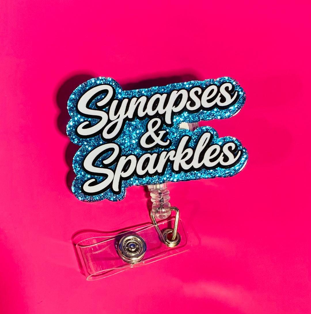 Badge holder with 'Synapses & Sparkles' text on a pink background