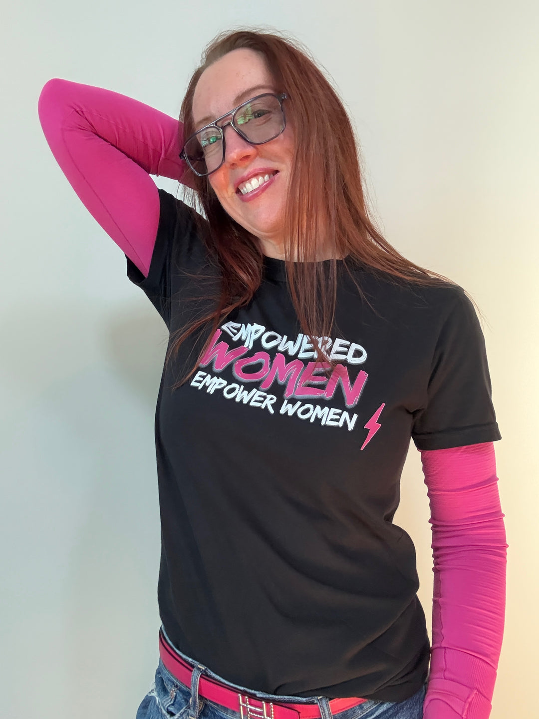 Ladyspinedoc wearing a black short sleeve t-shirt with the white and pink text 'EMPOWERED WOMEN EMPOWER WOMEN' on the front.