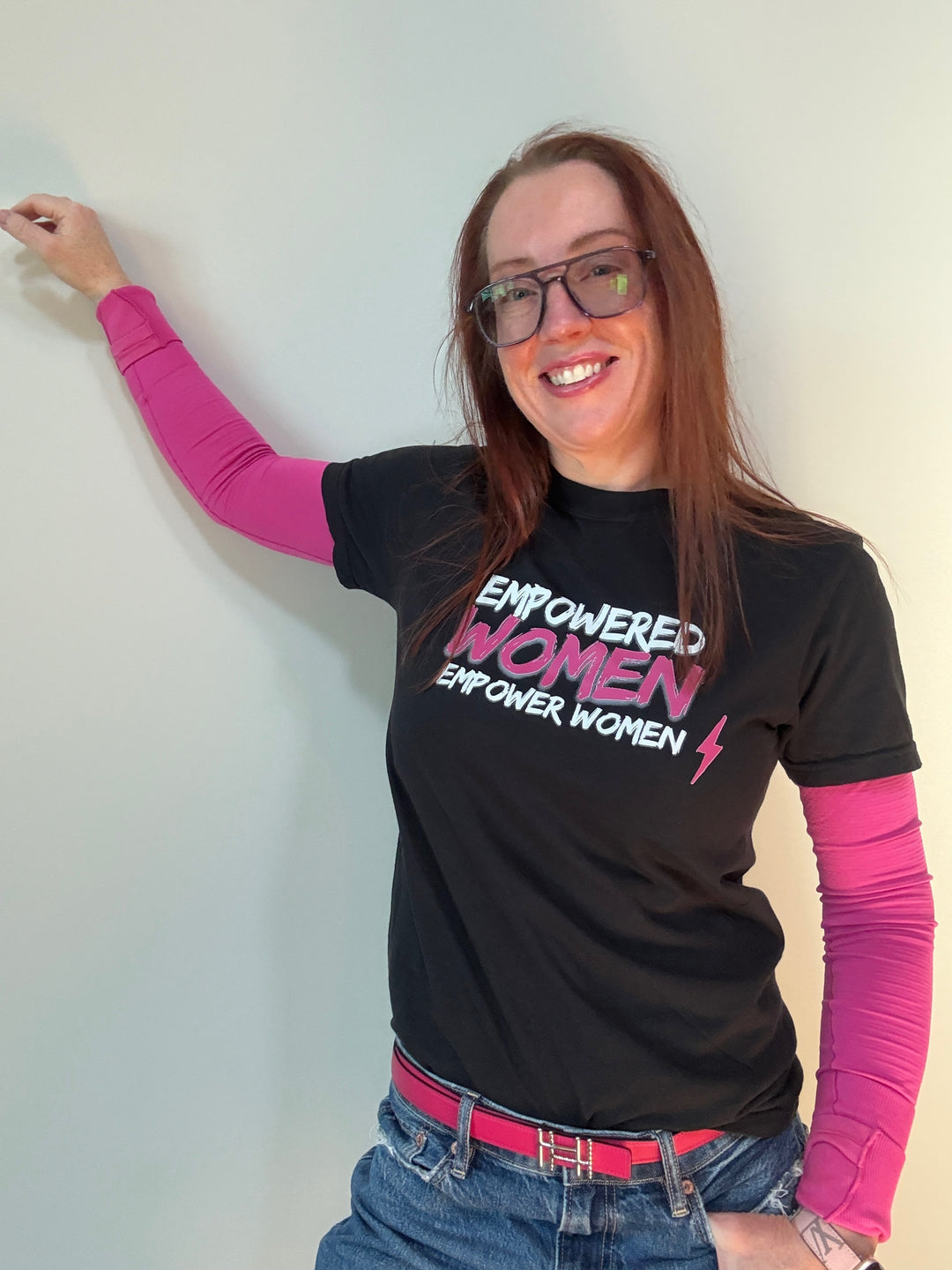 Ladyspinedoc wearing black short sleeve tee shirt with white and pink text 'EMPOWERED WOMEN EMPOWER WOMEN' and a lightning bolt graphic.