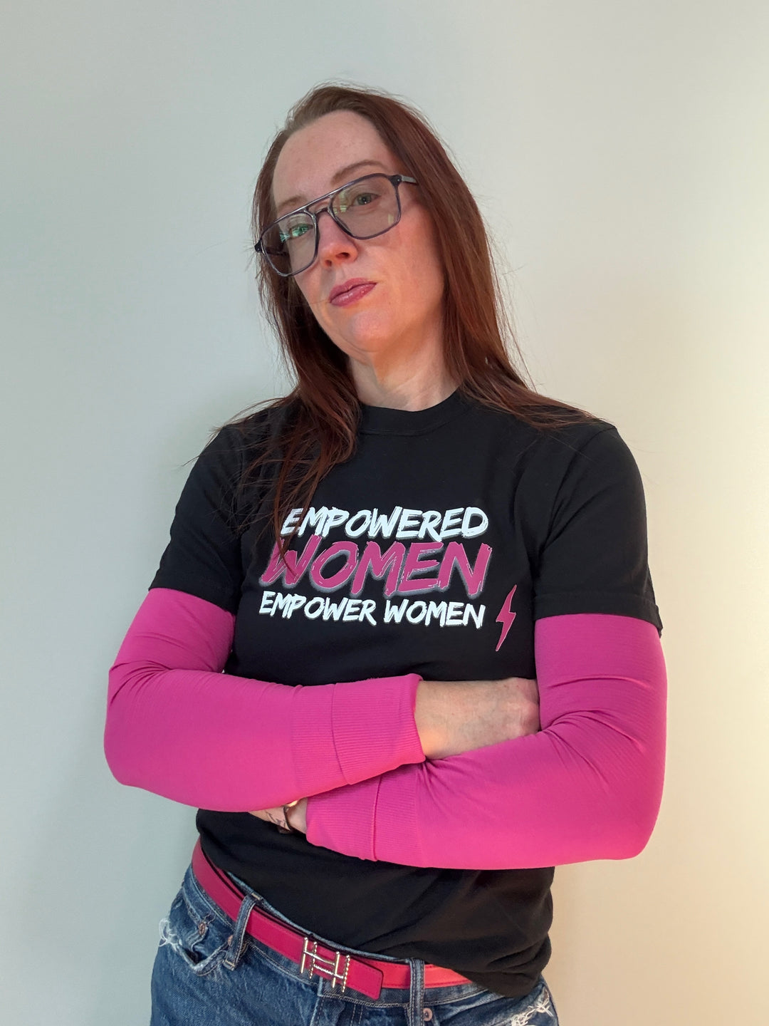 Ladyspinedoc wearing black short sleeve tee shirt with white and pink text 'EMPOWERED WOMEN EMPOWER WOMEN' and a lightning bolt graphic.